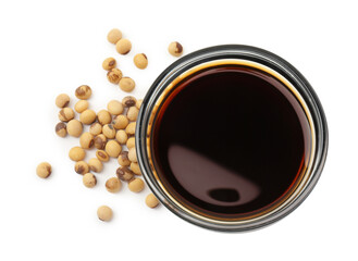 Tasty soy sauce in bowl and soybeans isolated on white, top view
