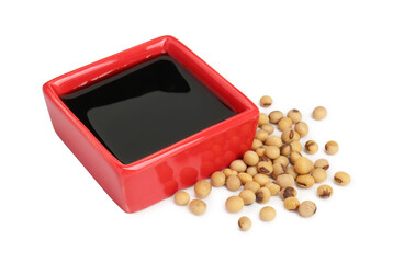 Tasty soy sauce in bowl and soybeans isolated on white