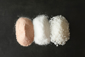 Obraz na płótnie Canvas Different types of organic salt on black table, top view