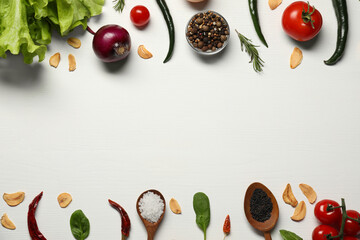 Cooking dinner. Different vegetables and spices on white wooden table, flat lay. Space for text