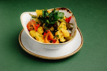 Pickled vegetables with cauliflower florets isolated on a green background