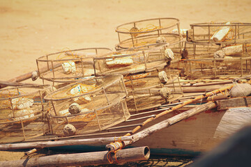 Traditional circular fish traps made from sturdy metal frame and plastic nets left to dry in the...