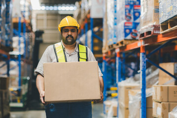 Warehouse worker working in warehouse storage. Foreman or worker work at factory site check up...