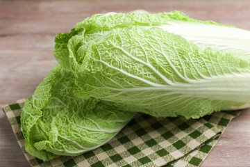 Fresh ripe Chinese cabbages on wooden table, closeup