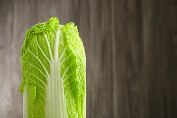 Fresh ripe Chinese cabbage against blurred background, closeup. Space for text - obrazy, fototapety, plakaty