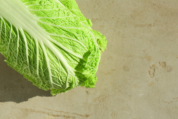 Fresh ripe Chinese cabbage on gray textured table, top view. Space for text - obrazy, fototapety, plakaty