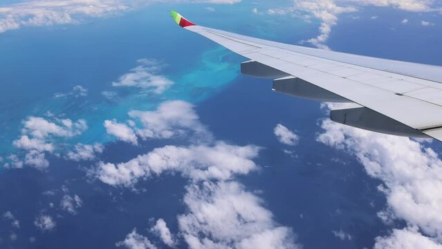 Plane Flying High Over Clear Blue Ocean Water. Caribbean Vacation.