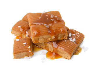 Yummy caramel candies and sea salt isolated on white
