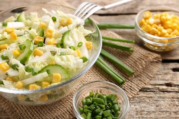 Tasty salad with Chinese cabbage served on wooden table, closeup