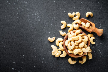 Cashew nuts in bowl at black background. Flat lay with space for text. - 783200881