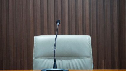selective focus table microphone with white chair in the meeting room for teleconference                                                                                                