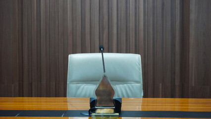 selective focus table microphone with white chair in the meeting room for teleconference                                                                                                