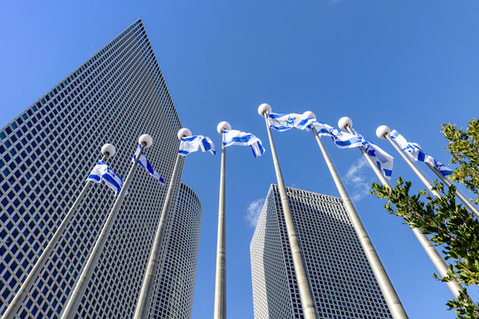 Israel, Tel Aviv, Israeli flags in financial business district skyline and shopping malls