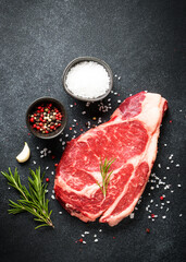 Meat steak. Beef steak dry aged with spices on black background. Top view. - 783205683