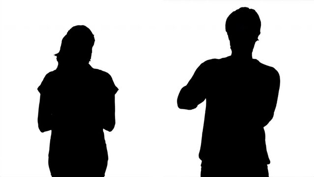 Male Female Silhouette Couple Sanitizing Hands Medium Shot. Silhouette of a man and a woman using a hand sanitizer. Medium shot