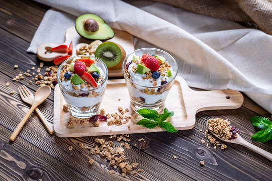 Greek Yogurt homemade with berries, avocado, banana and granola. It's healthy menu and low calories for people who diet. the high quality picture for artwork and graphic design