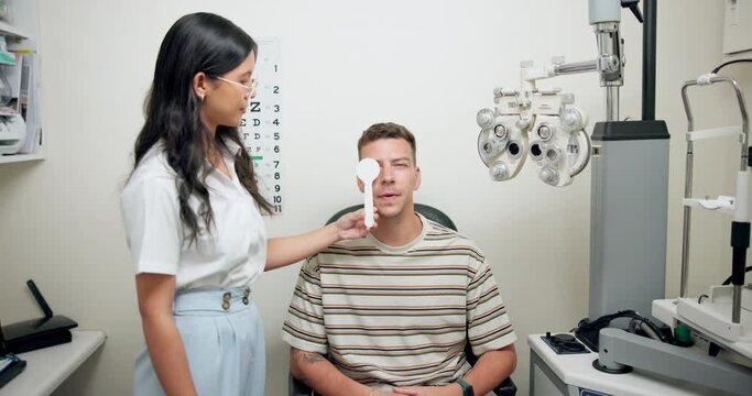 Doctor, patient and eye testing at office for vision with assistance, support and checkup for health care. Woman, optometrist and phoropter for eyesight or assessment, consultation and advice