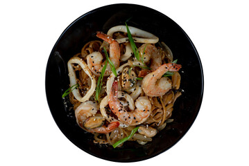 Asian wok noodles with with seafood and vegetables with chopsticks on the table. - 783220046