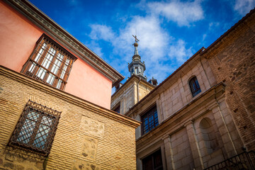 Street corner detail in Toledo, Castilla la Mancha, Spain, with one of the towers of the Town Hall building