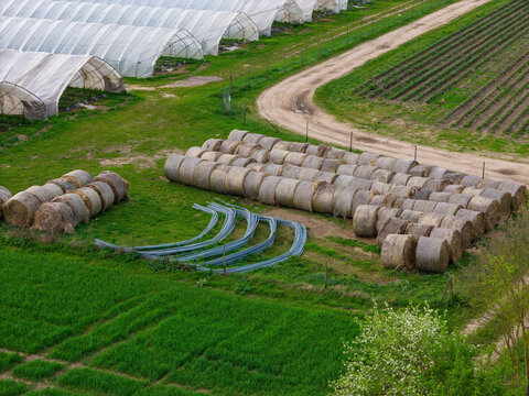 Greenhouses, straw bales and iron frames in agriculture near Weiterstadt
