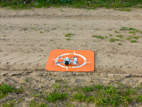 Weiterstadt Germany April 6, 2024: DJI Mini 3 drone with rotating propeller on land platform