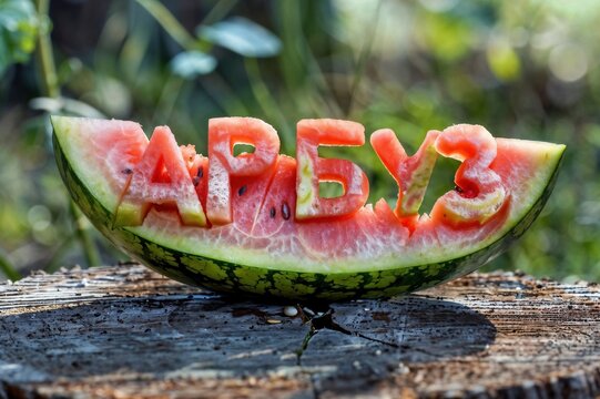 an image showing a watermelon in which the word WATERMELON is carved from a watermelon