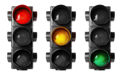 Trio of vertical traffic lights displaying red, yellow, and green signals, cut out