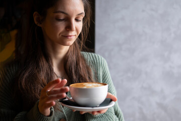Serene Morning Moment With A Woman Savoring Her fresh Coffee cup Indoors