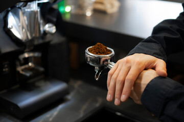 Barista Precisely Measures Ground Coffee for Espresso in a Portafilter at a Modern Cafe
