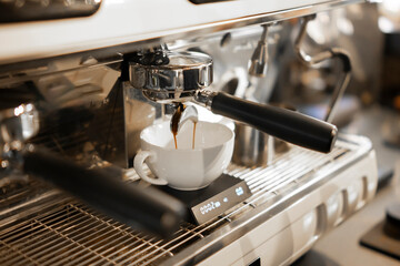 Espresso pouring in white cup close up, Preparation at a Modern Coffee Machine Showing Time and Weight