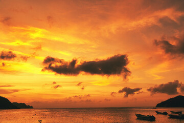 Landscape with beautiful sunset on the sea and boats on the shore. Taganga Beach. Santa Marta,...