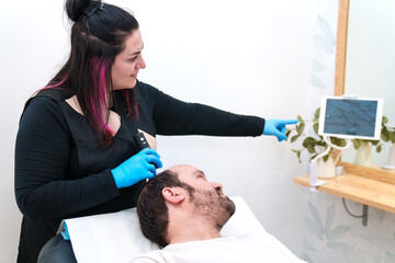 Healthcare professional provides a scalp examination for a client.