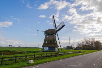 A typical Dutch windmill as a polder mill with paddle wheel for draining the polders in the...