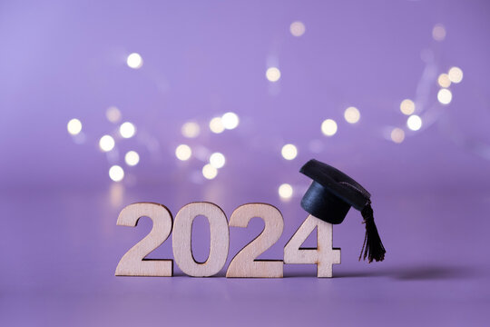 Number 2024 with graduated cap and bokeh lights. Class of 2024 concept