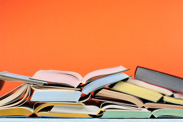 Open book, hardback colorful books on wooden table. Back to school. Copy space for text. Education business concept.