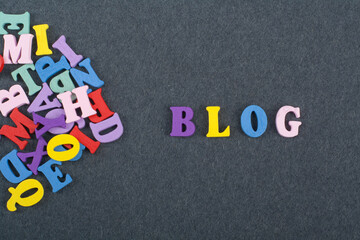 BLOG word on black board background composed from colorful abc alphabet block wooden letters, copy space for ad text. Learning english concept.