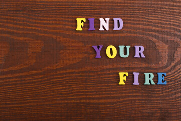 FIND YOUR FIRE word on wooden background composed from colorful abc alphabet block wooden letters,...