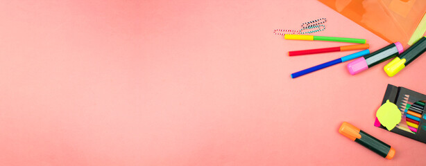 Back to school. Stationery on a salmon color table. Office desk with copy space. Flat lay. Banner design.