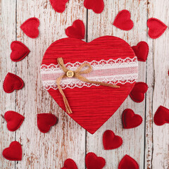 Valentine's day gift. Banner design with present box and hearts on wooden background.