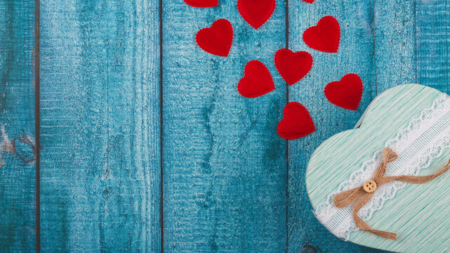 Valentine's Day background with hearts and gift box.