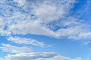 White clouds in a bright blue sky. The beauty of the nature	