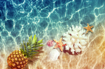 Yellow pineapple, seashells and starfish on a blue water background. - 783272068