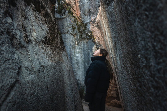 Woman Walking Between Giant Stones