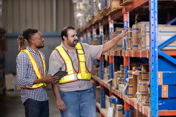 Warehouse workers inspect of products on warehouse shelves