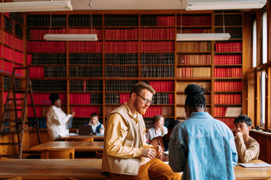 Professor and assistant working with students  