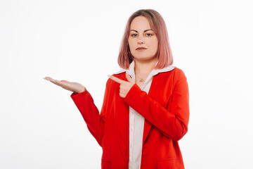 Stylish Young Woman Directing Attention to Her Hand, Promoting a Product, Presentation of Goods, standing against white background