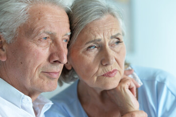 Close up portrait of sad senior couple posing 