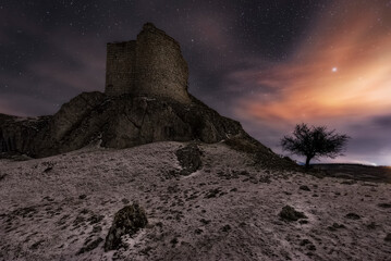Night view of the ruins of the medieval castle of Monasterio de Rodilla, Burgos, in the region of La Bureba, declared a site of cultural interest and historical heritage of Spain - obrazy, fototapety, plakaty