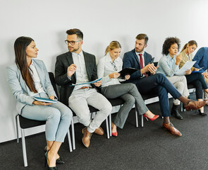 man business chair sitting waiting businessman candidate recruitment office businesswoman woman businessperson job young interview line employee career row hall colleague