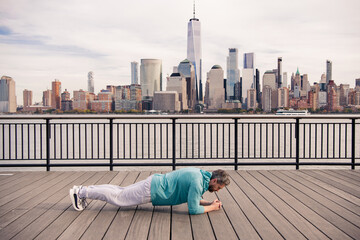 Man Doing Exercises in New York City outdoor. Happy man workout in New York city. Senior runner motivation for fitness, energy and healthy exercise training. Sport, fitness and exercise.